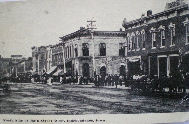 Circa 1914. Known as 'bank corner'. Building in the middle is Farmers State Savings Bank (now Bank Iowa). To the right (now Majestic corner) was known as "McCleanon Block" (see name at top of building).